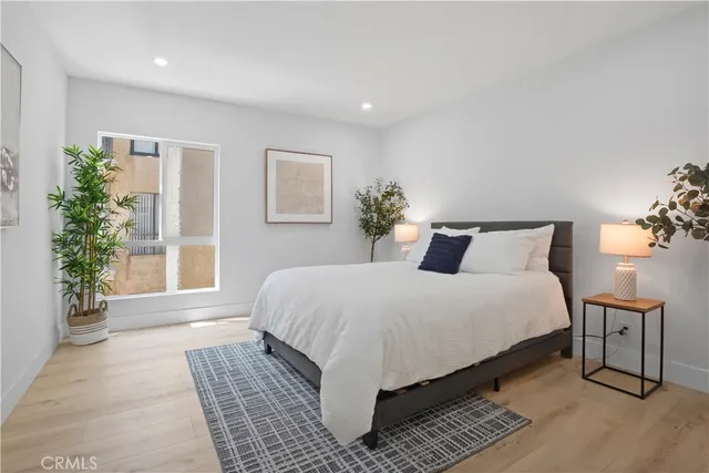 a bedroom with a large bed and a window