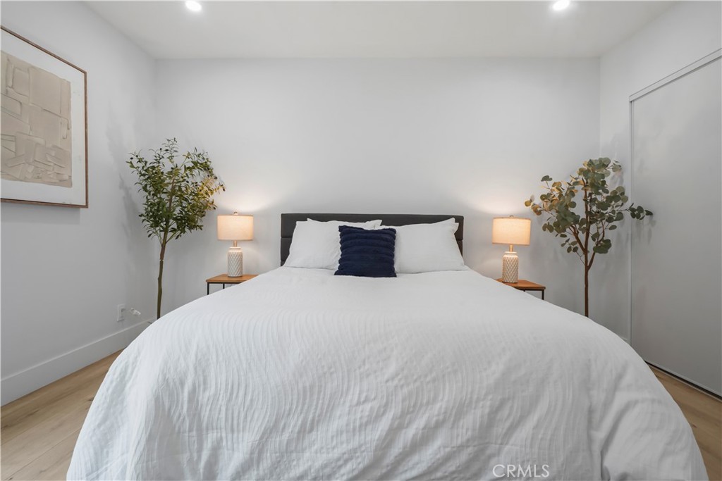 1730 Camino Palmero Street, Unit 316 Los Angeles, CA 90046 - Photo 18 of 27 a bedroom with a bed and a potted plant