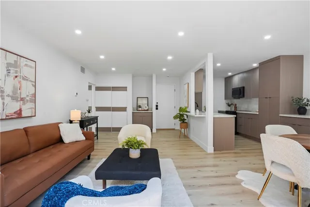 a living room with furniture kitchen and a table