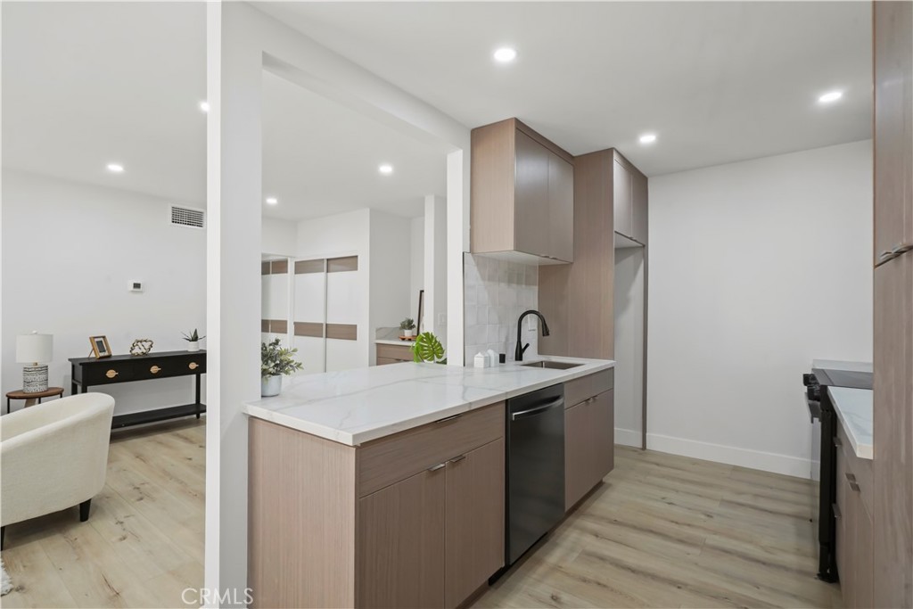 1730 Camino Palmero Street, Unit 316 Los Angeles, CA 90046 - Photo 2 of 27 a kitchen with a sink appliances and cabinets