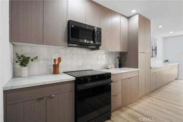 a kitchen with a sink stove and microwave