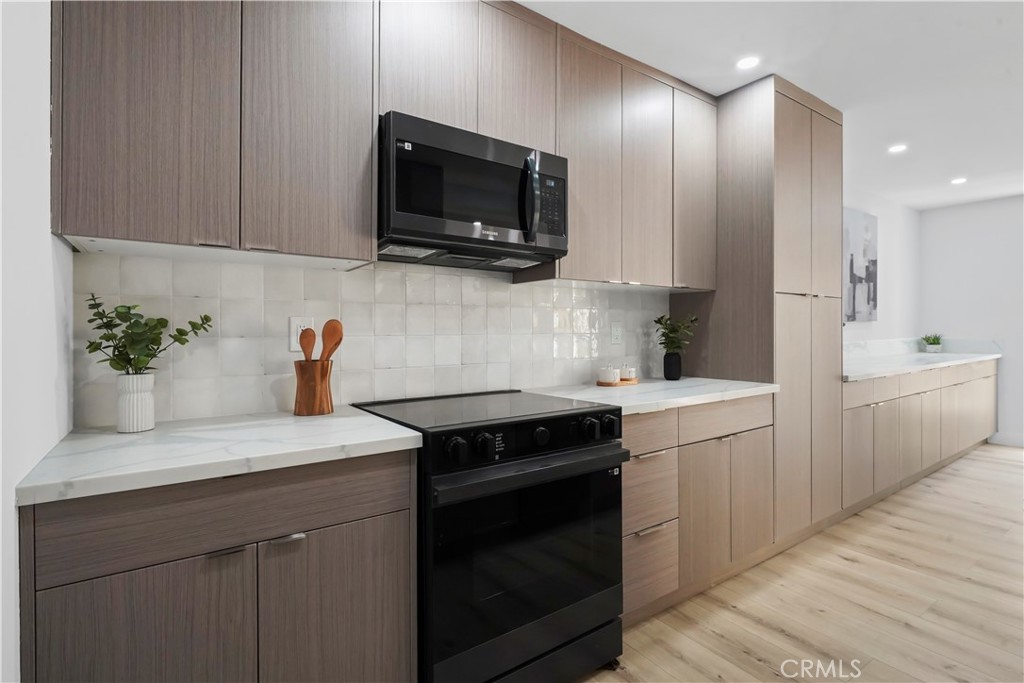 1730 Camino Palmero Street, Unit 316 Los Angeles, CA 90046 - Photo 4 of 27 a kitchen with a sink stove and microwave