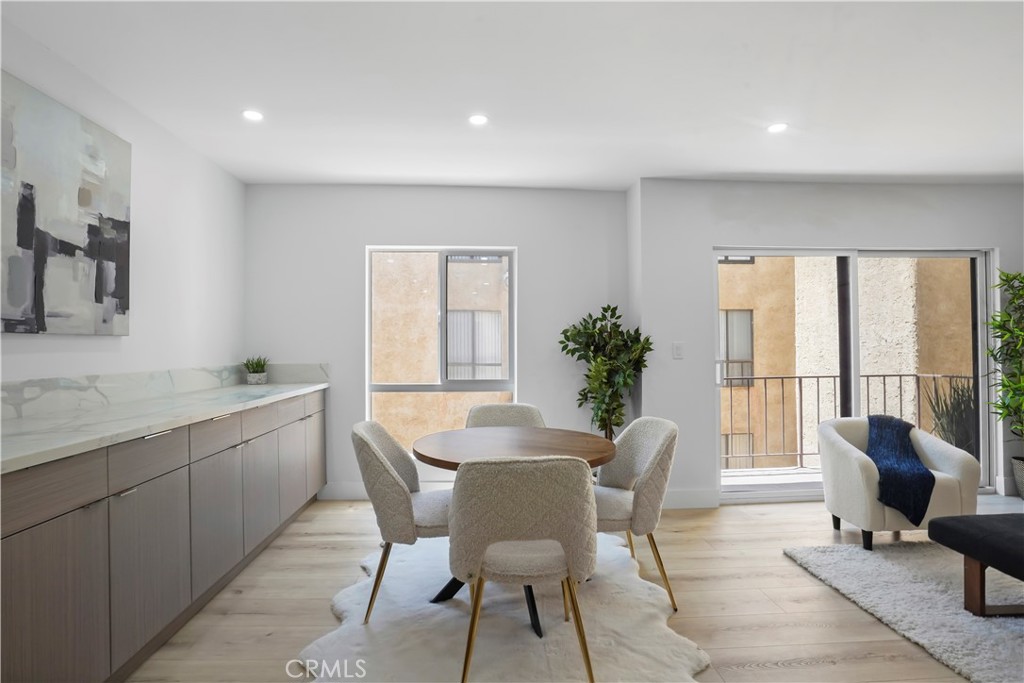 1730 Camino Palmero Street, Unit 316 Los Angeles, CA 90046 - Photo 5 of 27 a view of a dining room with furniture and a potted plant