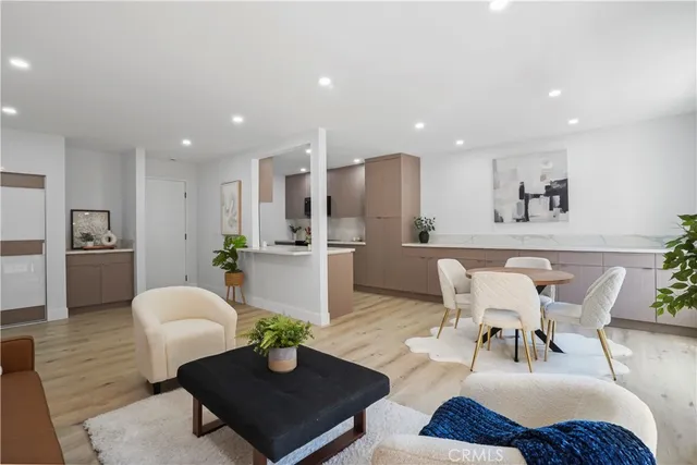 a living room with furniture kitchen and a table