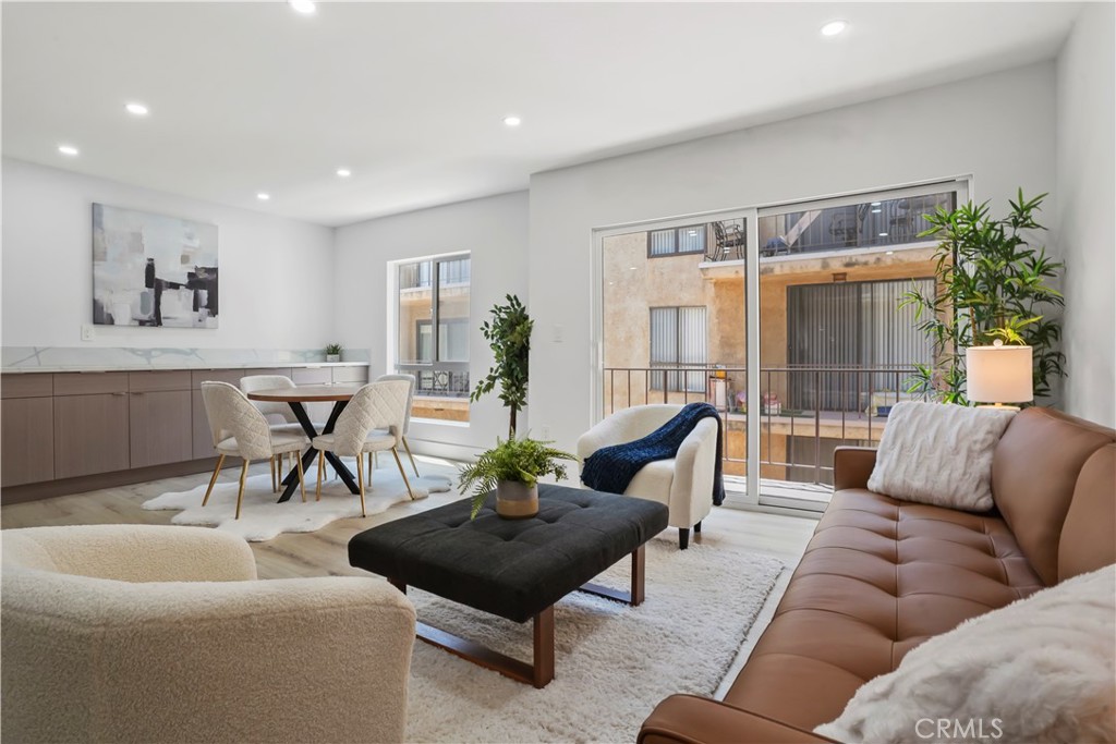 1730 Camino Palmero Street, Unit 316 Los Angeles, CA 90046 - Photo 10 of 27 a living room with furniture and a large window