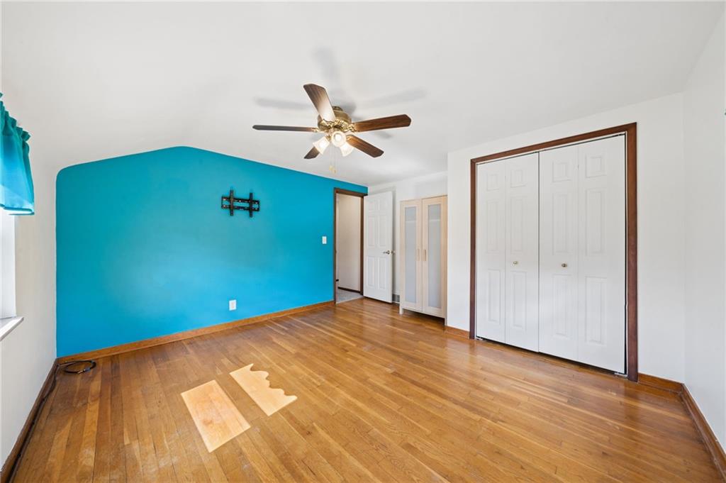 711 Jane Street Pittsburgh, PA 15239 - Photo 9 of 27 Generously sized primary bedroom featuring stunning hardwood floors and ample closet space.