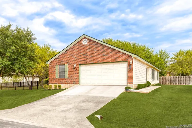 a view of backyard of house with green space