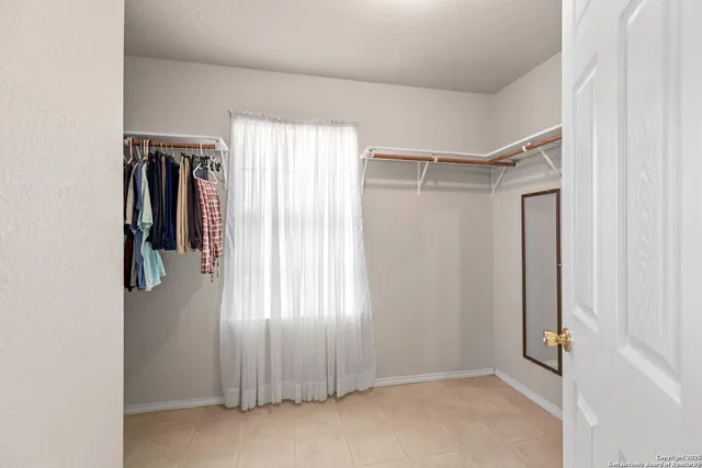 a view of walk in closet with window