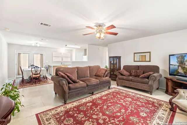 a living room with furniture a couch and a chandelier