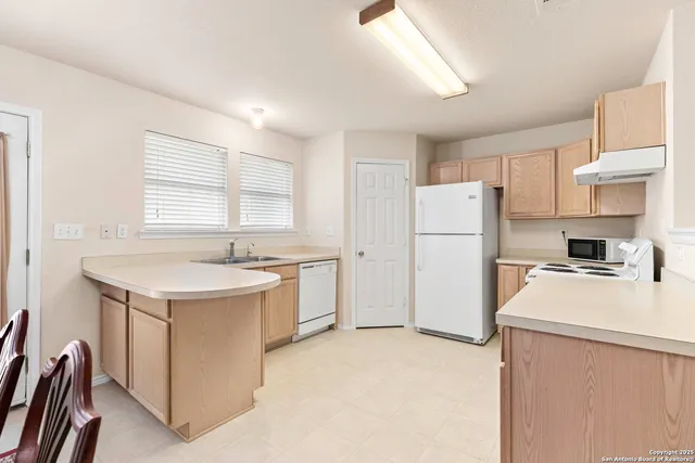 a kitchen with a refrigerator a stove a sink and a refrigerator