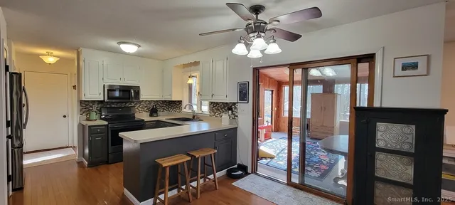 a kitchen with stainless steel appliances granite countertop a refrigerator a stove top oven a sink and dishwasher