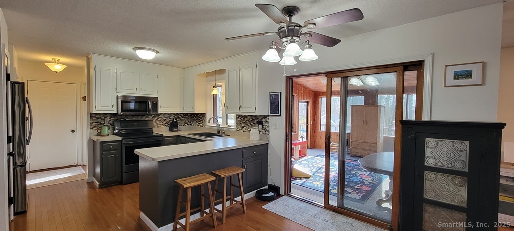48 Saddle Road Wolcott, CT 06716 - Photo 11 of 40 a kitchen with stainless steel appliances granite countertop a refrigerator a stove top oven a sink and dishwasher