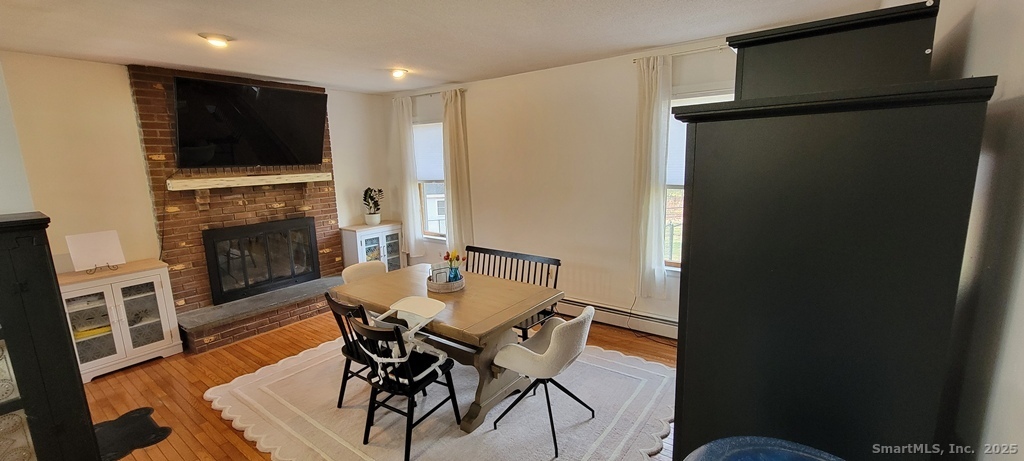 48 Saddle Road Wolcott, CT 06716 - Photo 13 of 40 a view of a dining room with furniture a fireplace and wooden floor