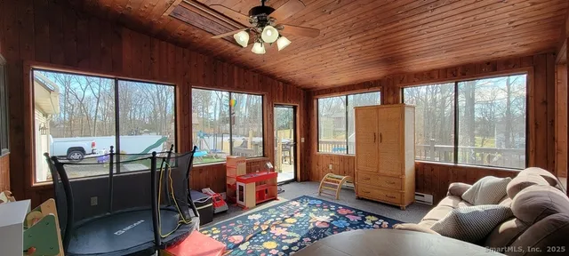 a living room with furniture and a floor to ceiling window