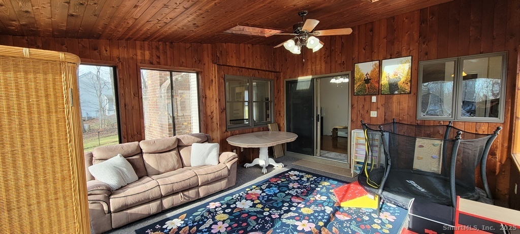 48 Saddle Road Wolcott, CT 06716 - Photo 22 of 40 a living room with furniture and a chandelier