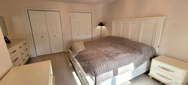 a bedroom with a bed and a tv