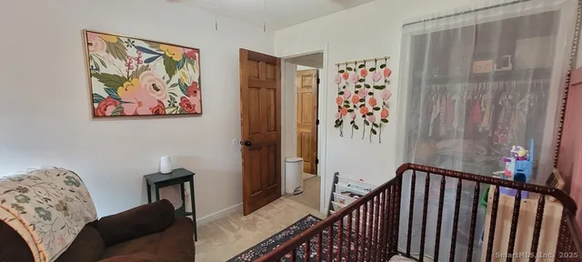 a view of a bedroom with furniture and workspace