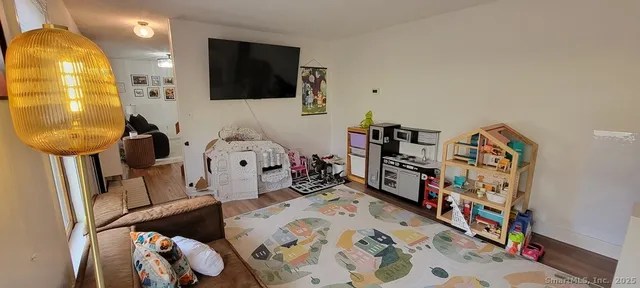 a bedroom with furniture and a flat screen tv