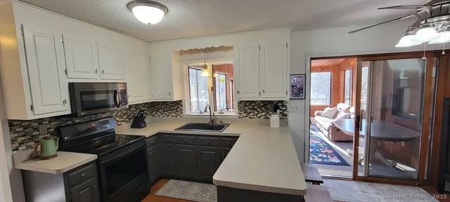 a kitchen with sink refrigerator and stove