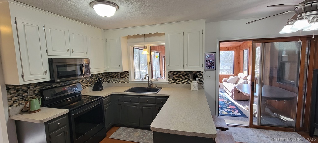 48 Saddle Road Wolcott, CT 06716 - Photo 10 of 40 a kitchen with sink refrigerator and stove