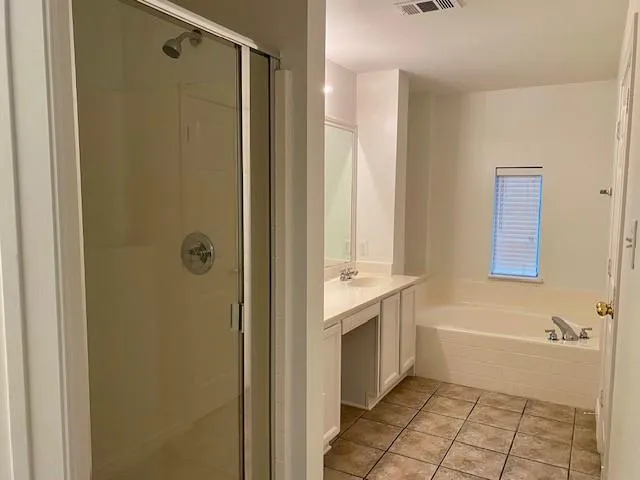 a bathroom with a tub shower and a sink