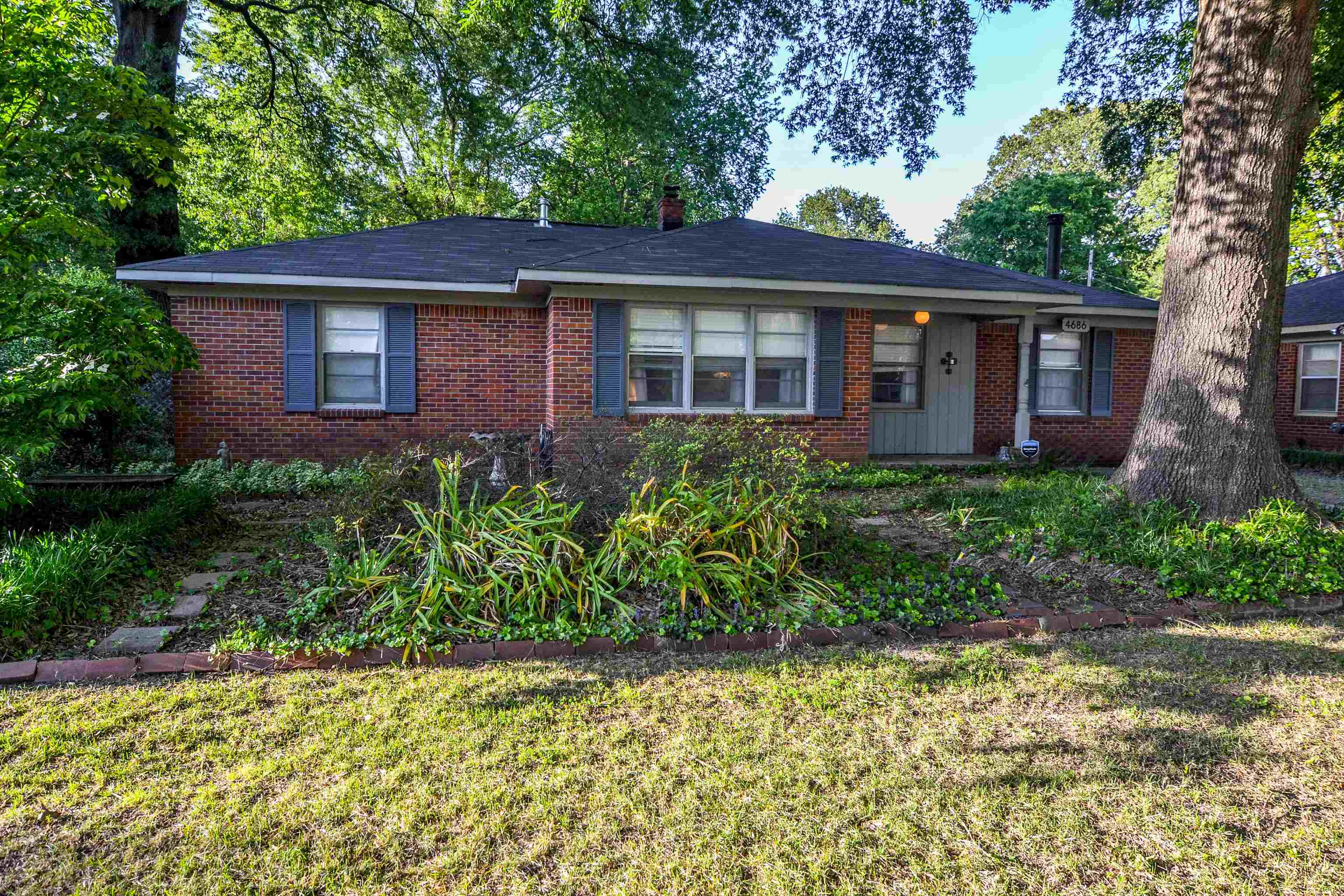 4686 Willow Road Memphis, TN 38117 - Photo 1 of 25 a front view of a house with a garden