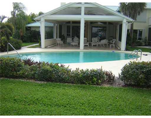 2391 Southwest Riverside Drive Palm City, FL 34990 - Photo 2 of 8 a view of a house with a yard porch and sitting area
