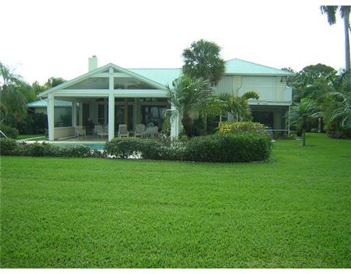 2391 Southwest Riverside Drive Palm City, FL 34990 - Photo 6 of 8 a front view of a house with garden