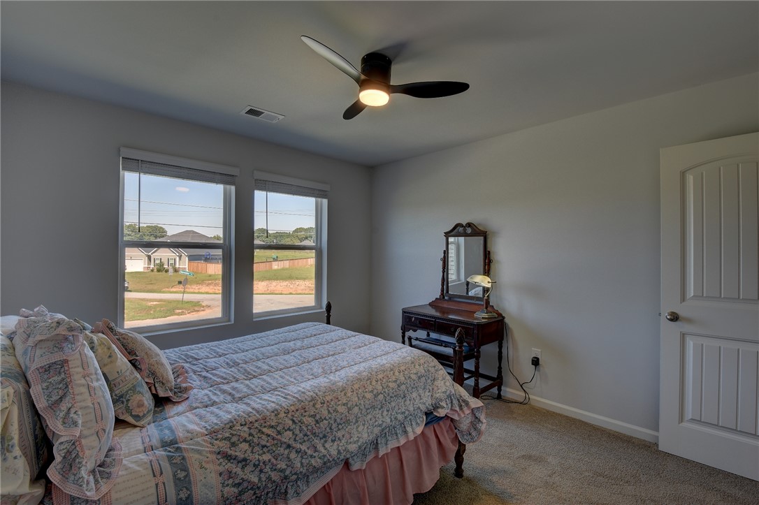 220 Clinkscales Road Anderson, SC 29624 - Photo 16 of 33 Double windows frame views of the neighborhood in this cozy bedroom with carpet flooring.