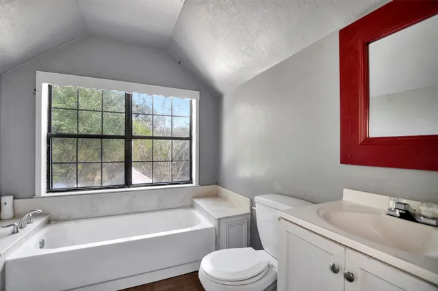 a bathroom with a sink a toilet and bathtub