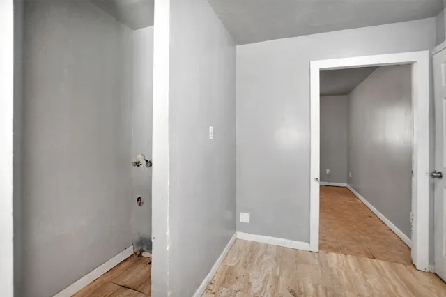a view of room with window and wooden floor