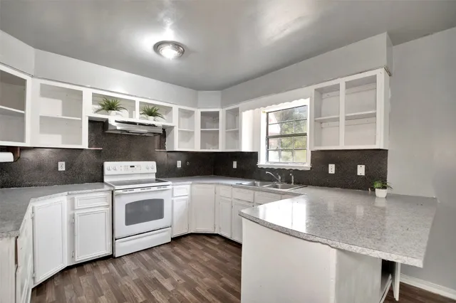 a kitchen with a stove and a sink