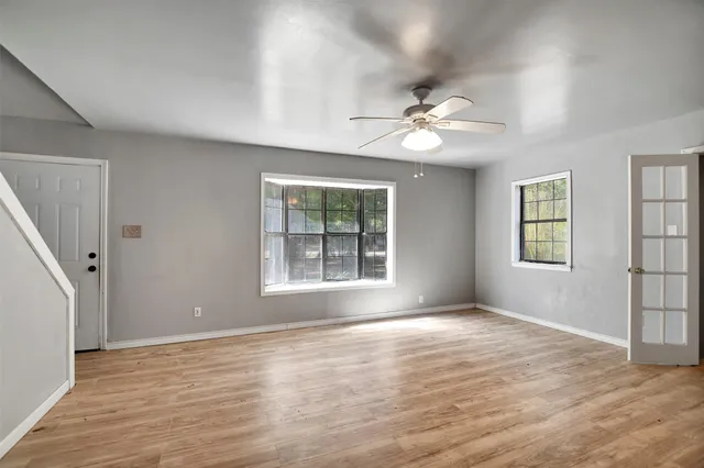 wooden floor in an empty room with a window