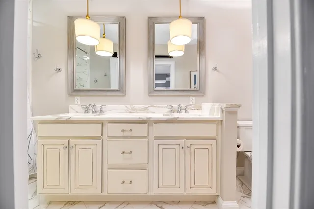 a bathroom with a shower and a sink