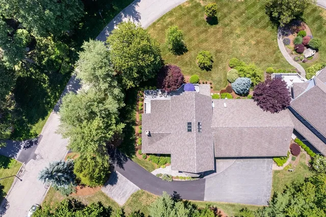 a front view of a house with a garden and plants
