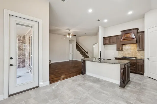 a kitchen with stainless steel appliances granite countertop a stove and a refrigerator