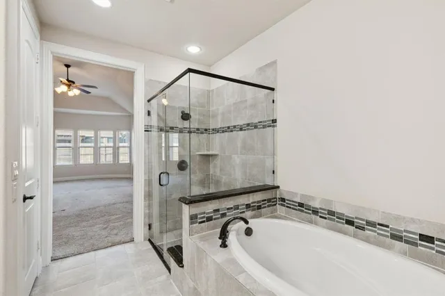 a bathroom with a tub and a shower