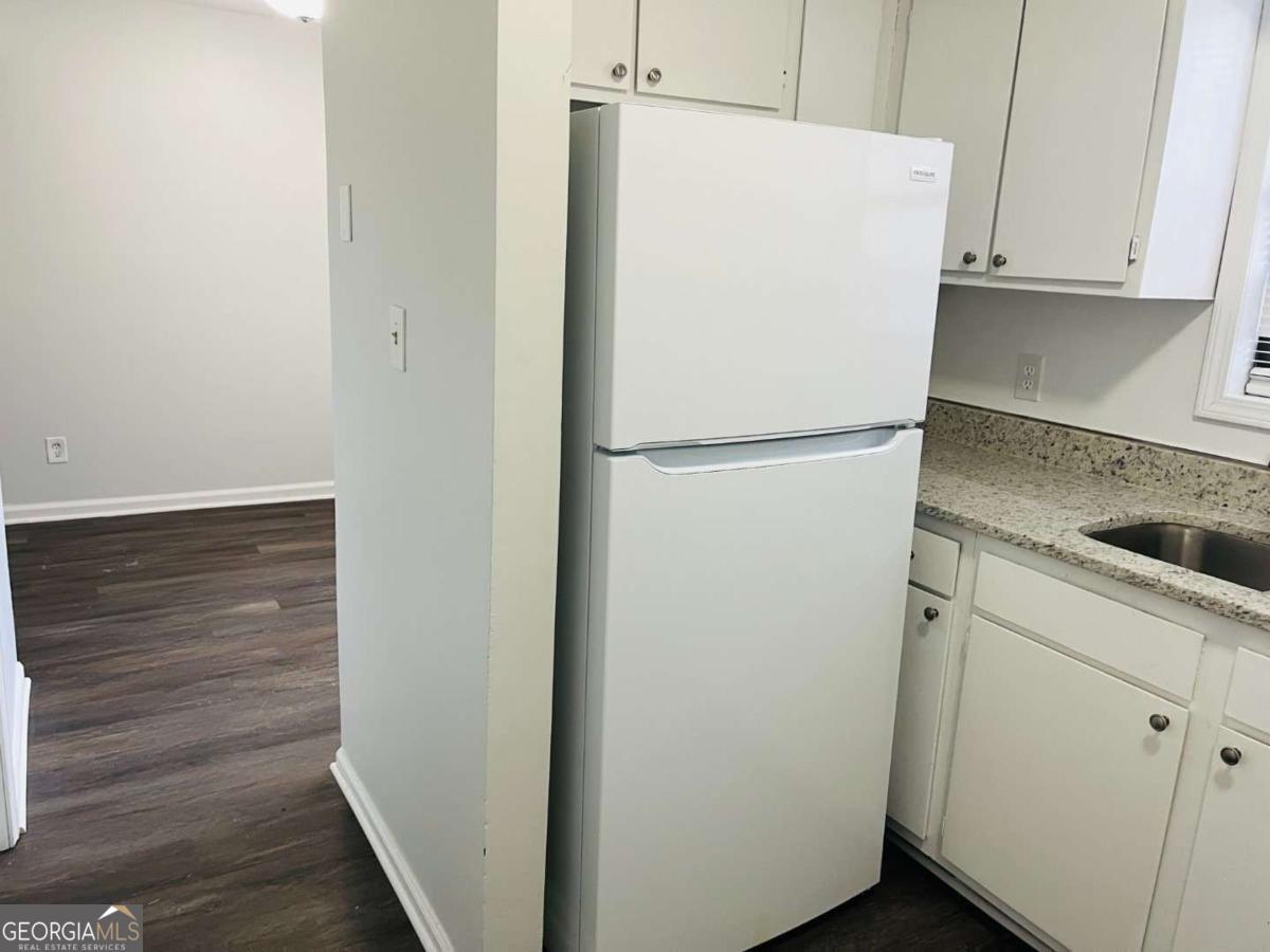 5614 Windwood Road, Unit 5614 Atlanta, GA 30349 - Photo 13 of 26 a white refrigerator freezer sitting inside of a kitchen
