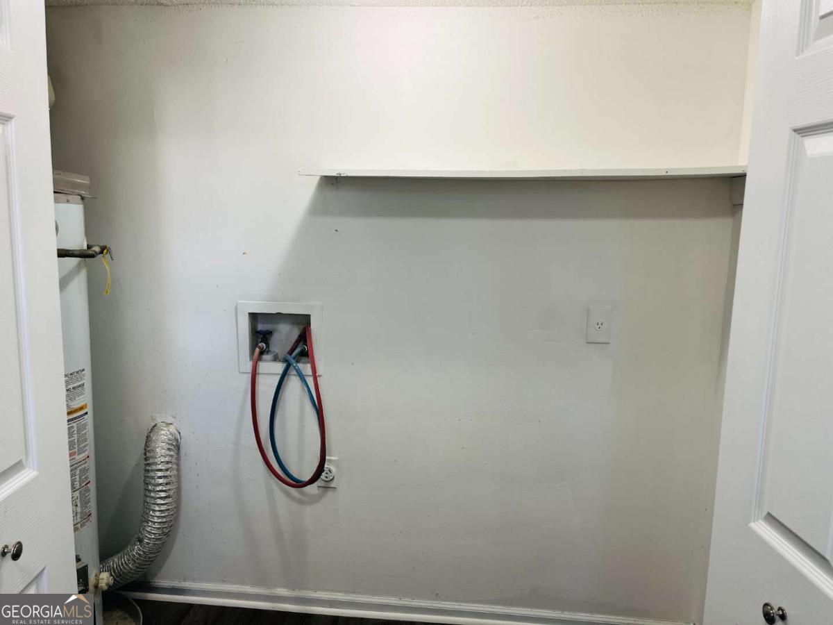 5614 Windwood Road, Unit 5614 Atlanta, GA 30349 - Photo 14 of 26 a bathroom with a glass shower door