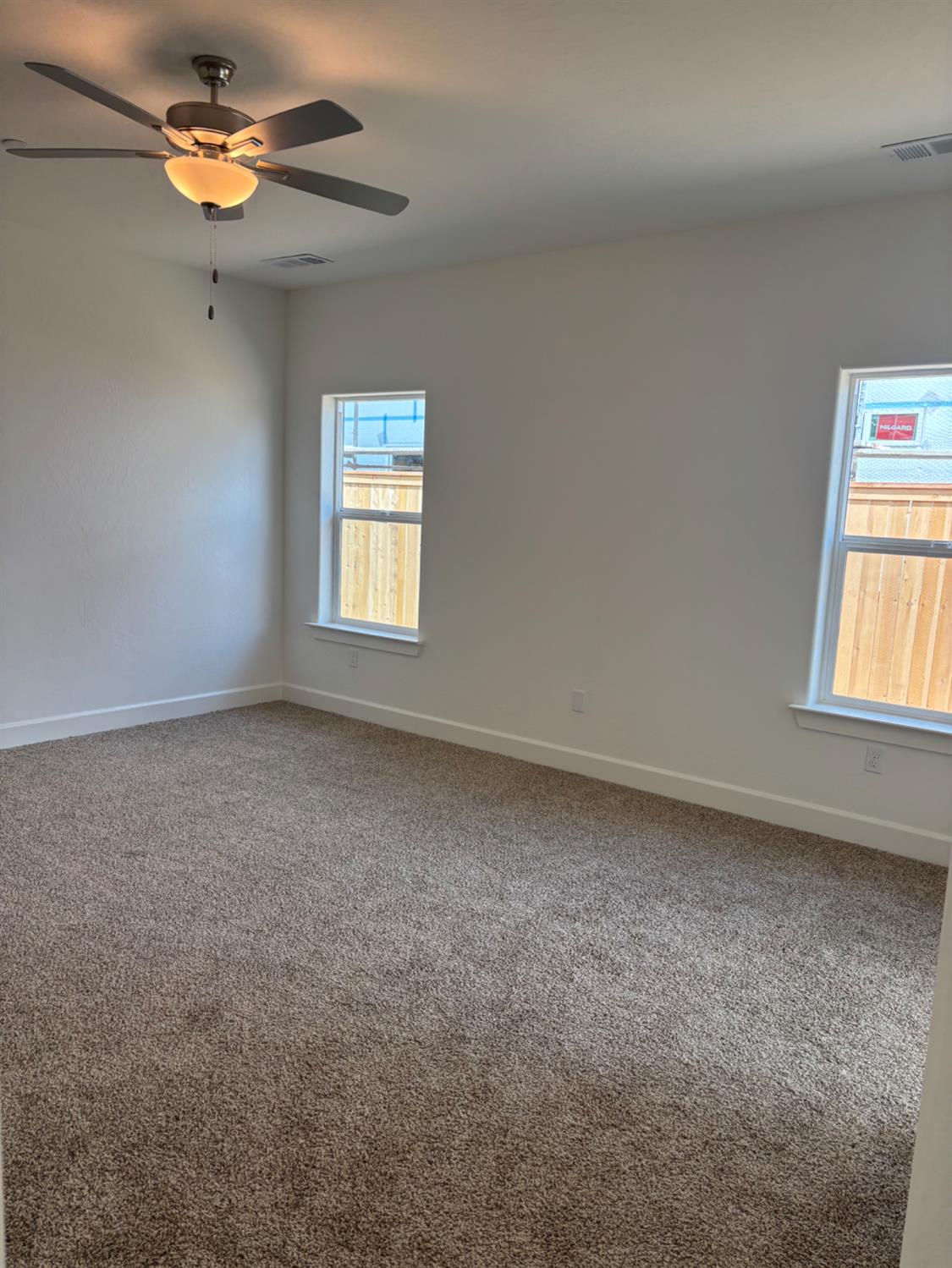 3808 Via Capitola Madera, CA 93637 - Photo 5 of 8 an empty room with windows and fan