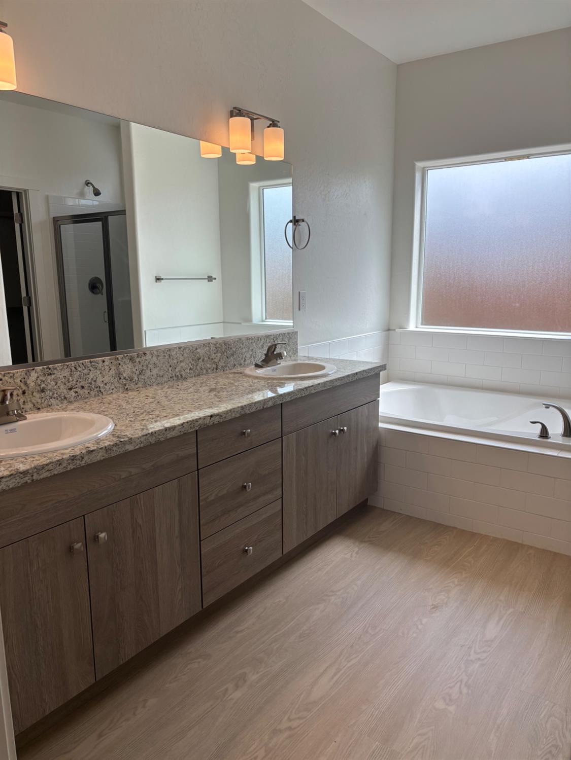 3808 Via Capitola Madera, CA 93637 - Photo 6 of 8 a spacious bathroom with a granite countertop sink mirror and a