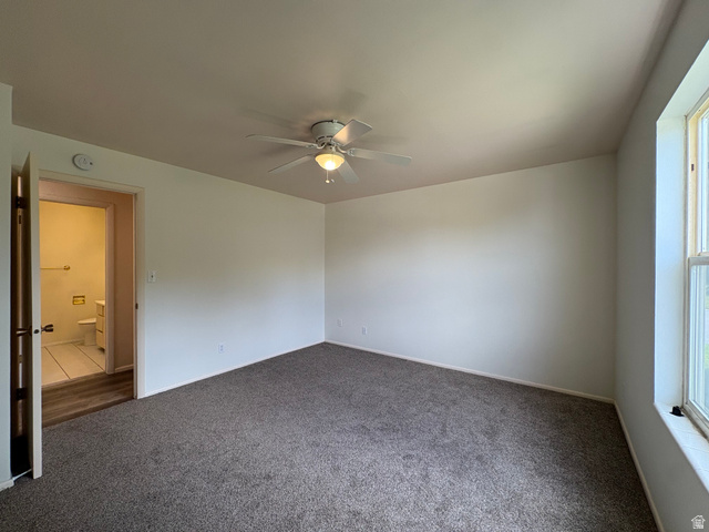 595 Meadowlark Road Orem, UT 84097 - Photo 39 of 87 Spacious room featuring neutral carpeting, a ceiling fan with integrated lighting, and a large window providing natural illumination