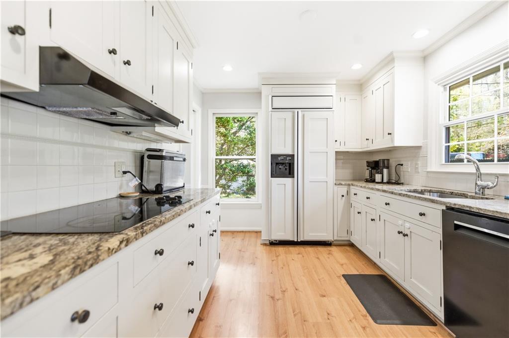 2864 Briarlake Road Northeast Atlanta, GA 30345 - Photo 11 of 77 a large kitchen with stainless steel appliances granite countertop a lot of counter space and wooden floors