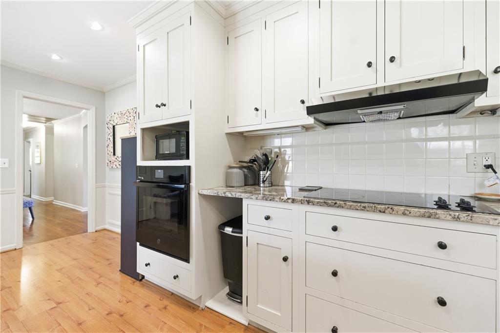 2864 Briarlake Road Northeast Atlanta, GA 30345 - Photo 13 of 77 a kitchen with granite countertop white cabinets and stainless steel appliances