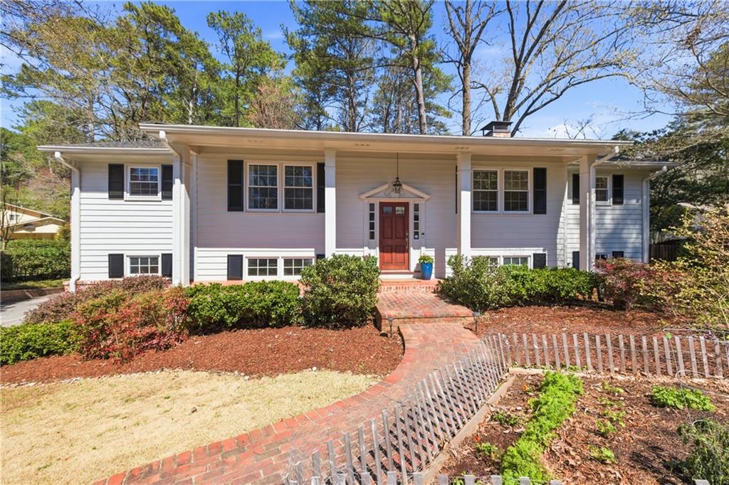 2864 Briarlake Road Northeast Atlanta, GA 30345 - Photo 2 of 77 a front view of a house with a yard and flower plants