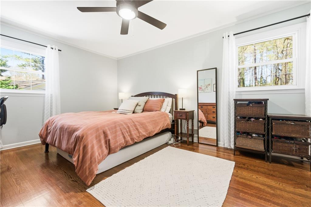 2864 Briarlake Road Northeast Atlanta, GA 30345 - Photo 29 of 77 a spacious bedroom with a bed and a dresser next to a window