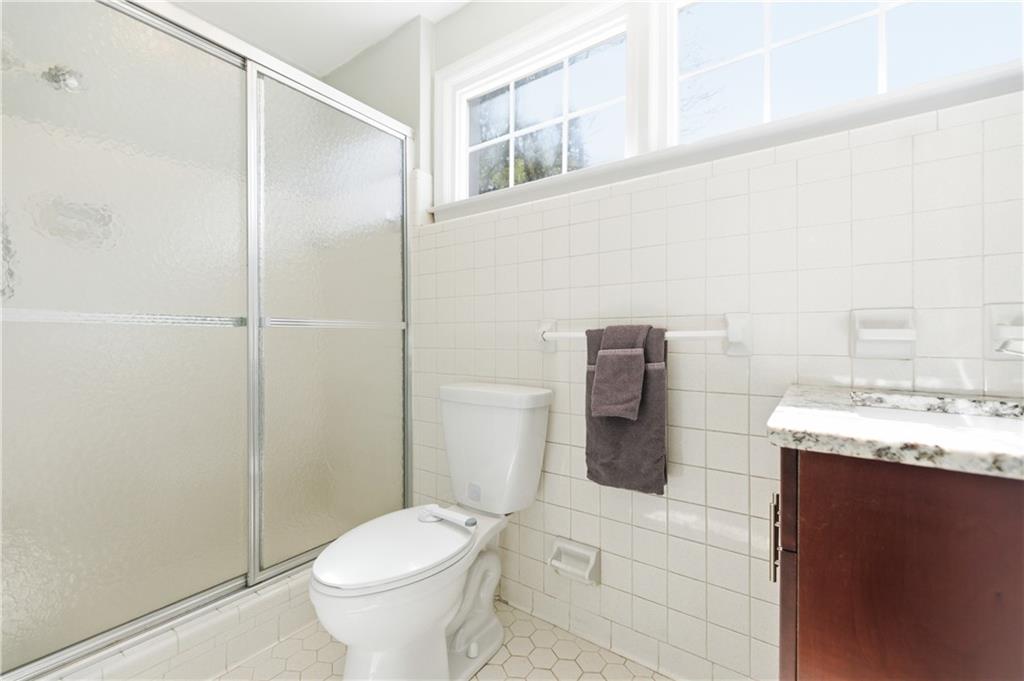 2864 Briarlake Road Northeast Atlanta, GA 30345 - Photo 47 of 77 a bathroom with a granite countertop toilet and a sink