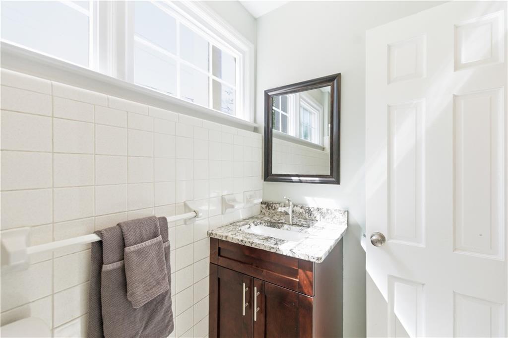 2864 Briarlake Road Northeast Atlanta, GA 30345 - Photo 48 of 77 a bathroom with a granite countertop sink and a mirror