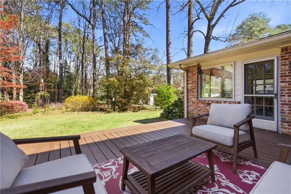 2864 Briarlake Road Northeast Atlanta, GA 30345 - Photo 57 of 77 a view of a backyard with table and chairs potted plants and a large tree