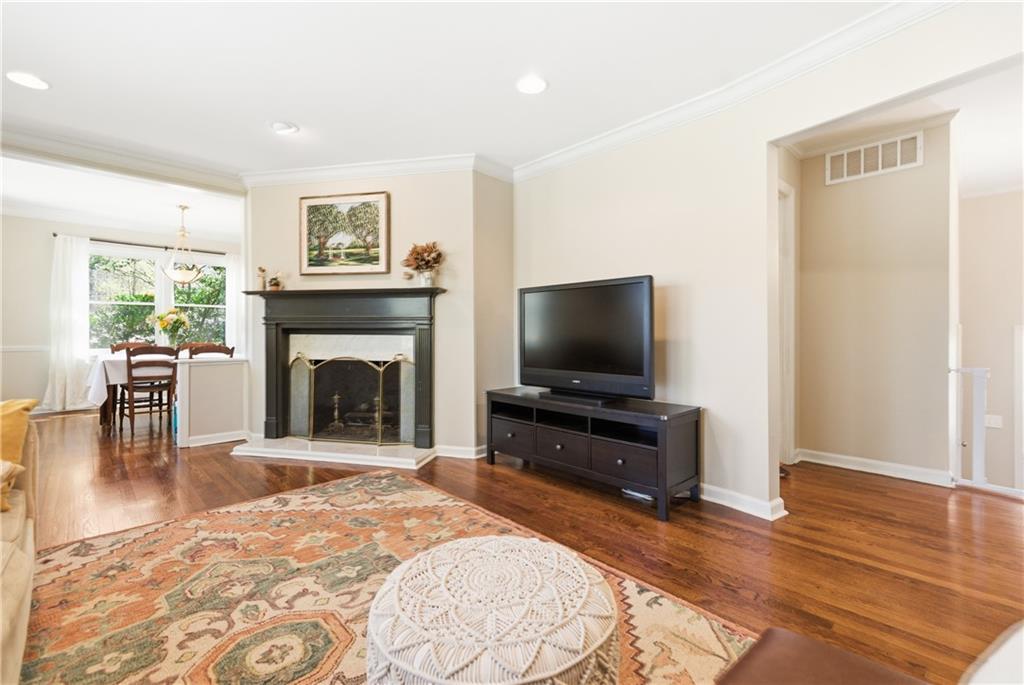 2864 Briarlake Road Northeast Atlanta, GA 30345 - Photo 9 of 77 a living room with furniture a flat screen tv and a fireplace